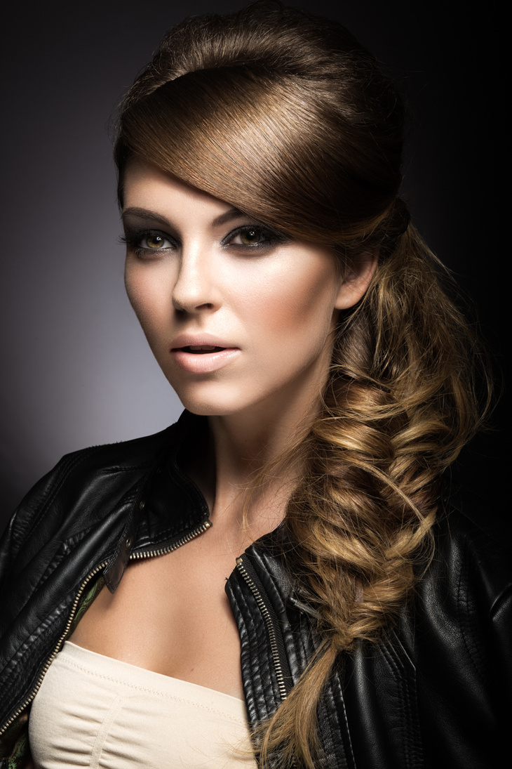 Beautiful girl with bright make-up, perfect skin and braid hairstyle